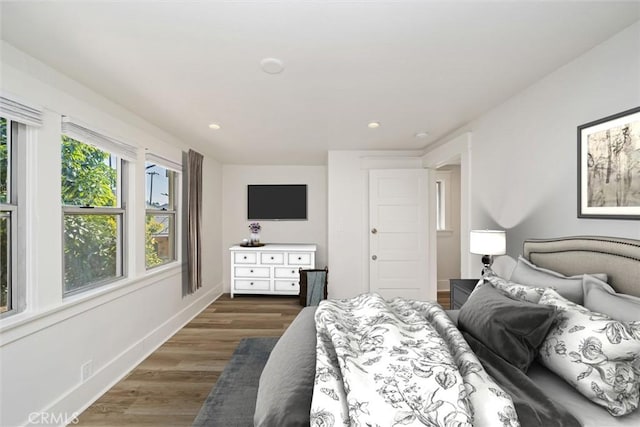 bedroom with dark hardwood / wood-style flooring