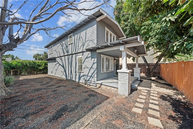 view of side of property featuring a patio area