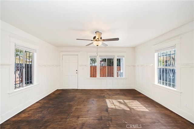 spare room with ceiling fan and dark hardwood / wood-style floors