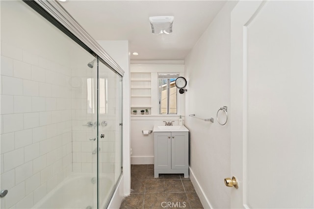 full bathroom with toilet, shower / bath combination with glass door, and vanity