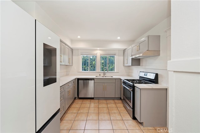 kitchen with sink, light tile patterned floors, gray cabinetry, and appliances with stainless steel finishes