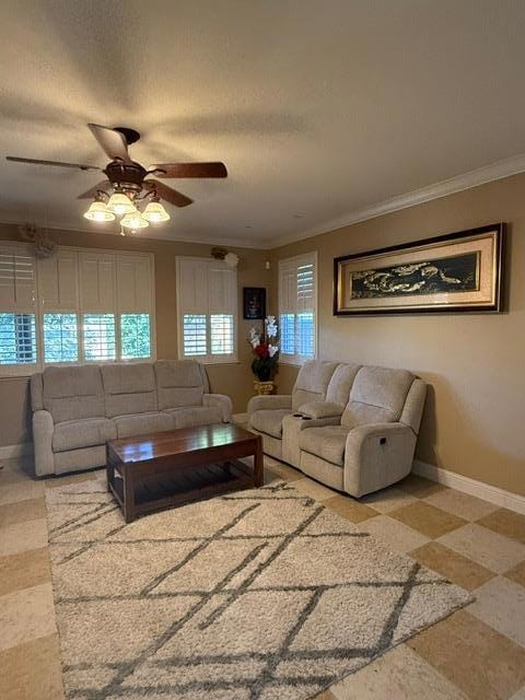 living room featuring ornamental molding and ceiling fan