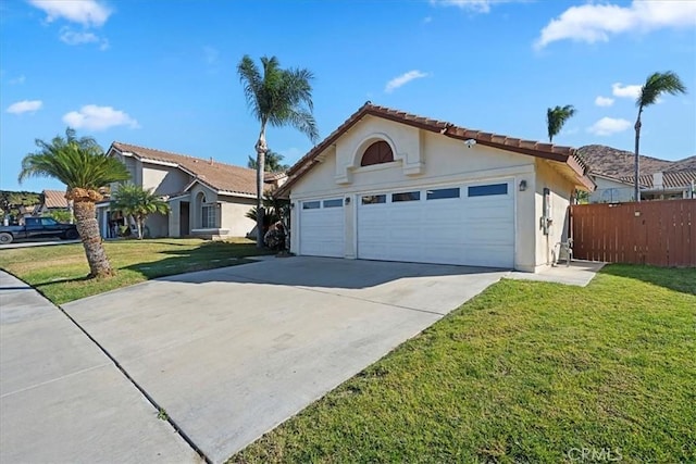 view of front of property featuring a front lawn and a garage