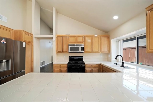 kitchen featuring appliances with stainless steel finishes, visible vents, a sink, and tile countertops