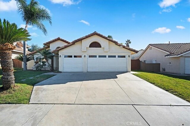 view of front of property with a garage and a front lawn