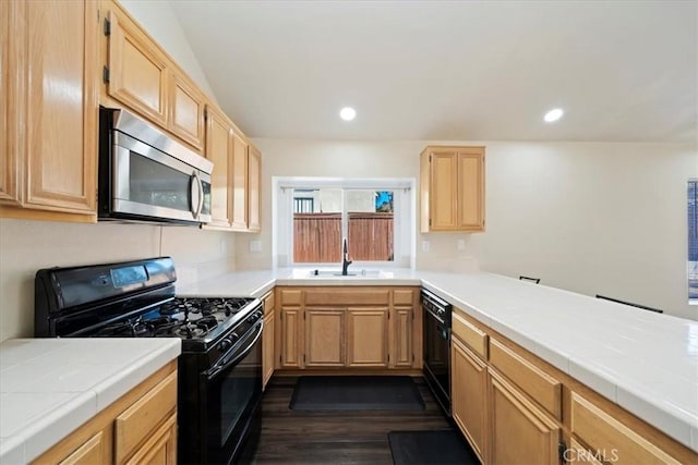 kitchen featuring black appliances, recessed lighting, a sink, and light brown cabinetry