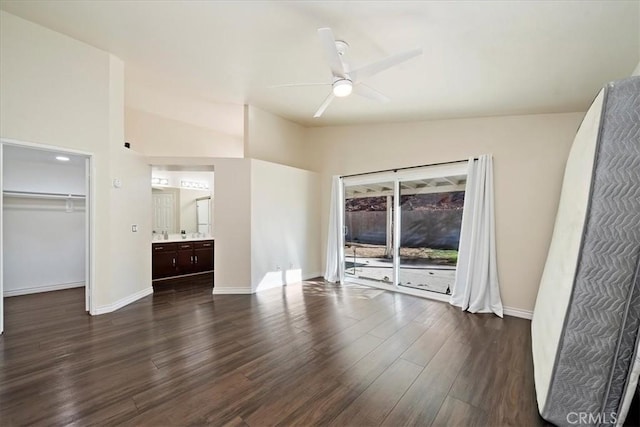 unfurnished bedroom featuring baseboards, lofted ceiling, dark wood-style floors, ceiling fan, and access to exterior