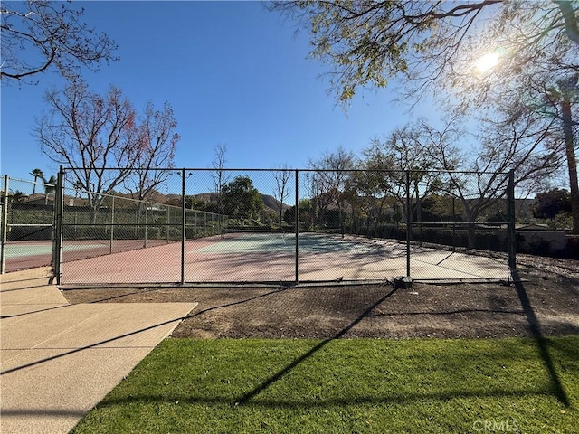 view of tennis court with fence