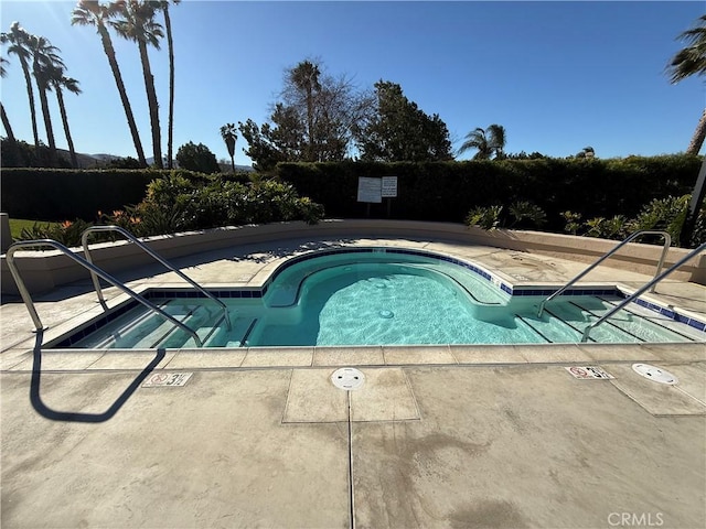 view of pool with a pool, a patio, and a hot tub