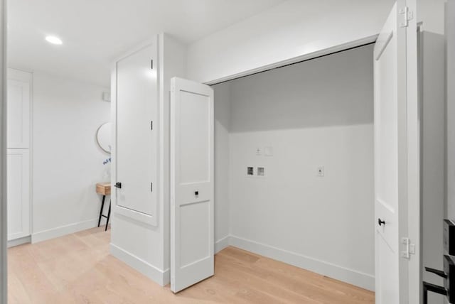 laundry area featuring washer hookup and light hardwood / wood-style floors