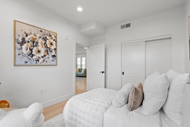 bedroom with a closet and light wood-type flooring