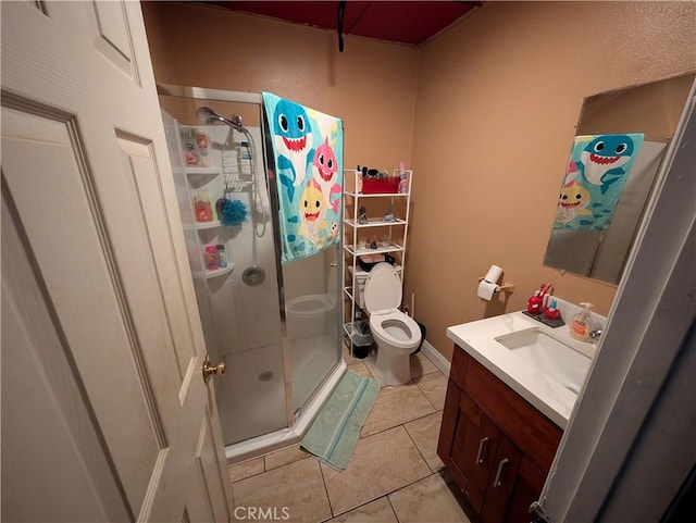 bathroom featuring a shower with door, vanity, tile patterned floors, and toilet