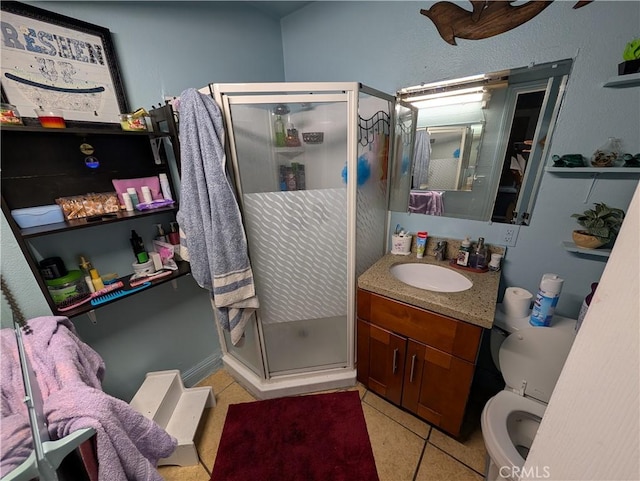 bathroom featuring tile patterned floors, vanity, toilet, and an enclosed shower