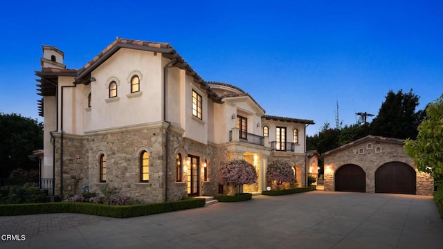 mediterranean / spanish-style home featuring a garage and an outdoor structure