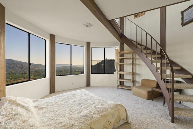 bedroom with carpet flooring and a mountain view