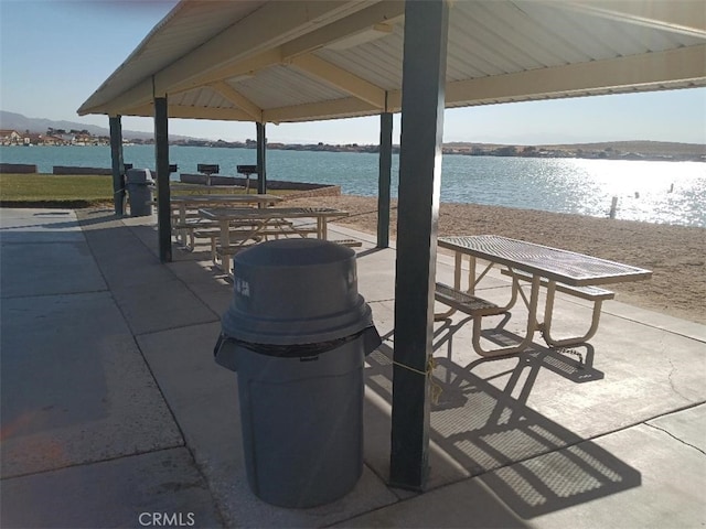 view of property's community featuring a gazebo, a water view, and a patio