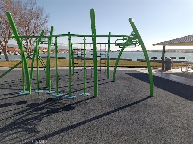 view of jungle gym featuring a water view