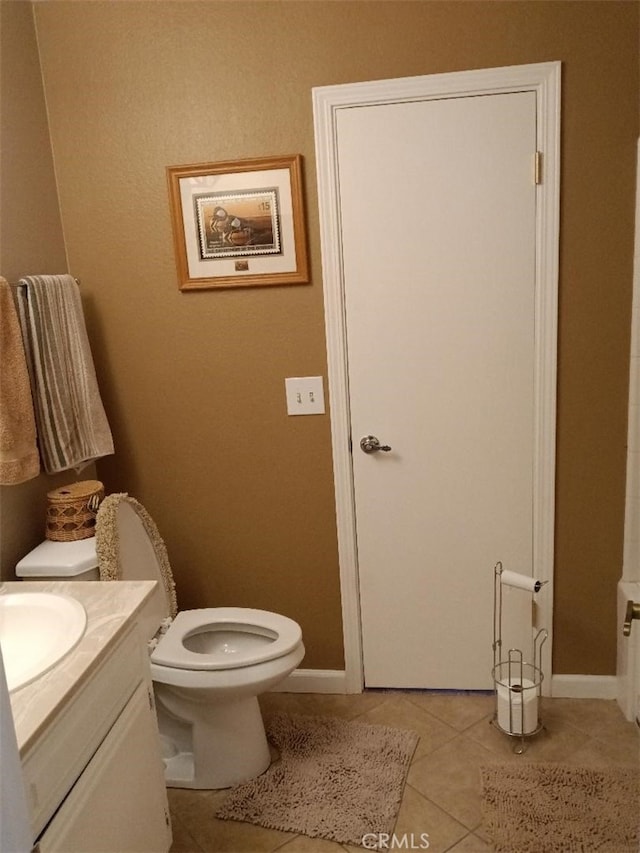 bathroom with vanity, tile patterned floors, and toilet