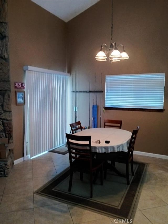 dining space with light tile patterned floors and a chandelier