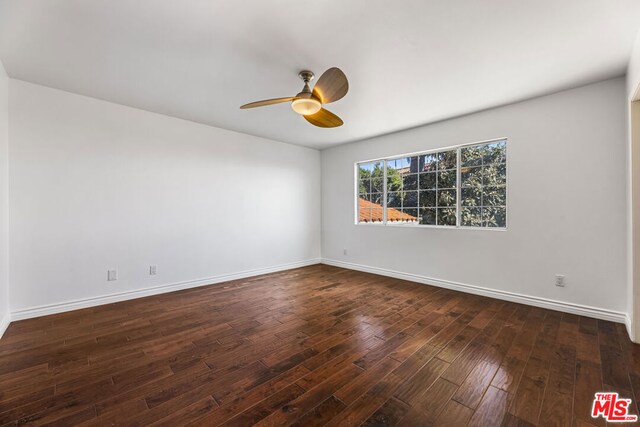 unfurnished room featuring ceiling fan and dark hardwood / wood-style flooring