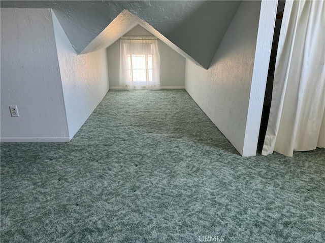 additional living space featuring lofted ceiling and carpet flooring