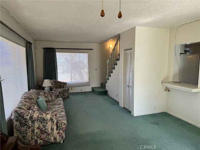 unfurnished living room with carpet flooring and a textured ceiling