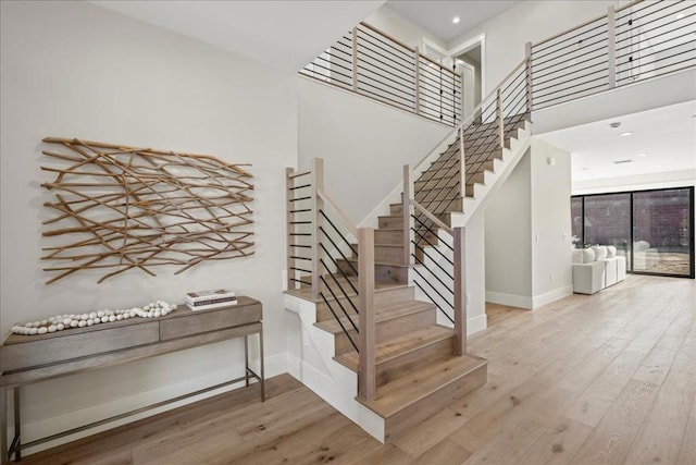 staircase with hardwood / wood-style flooring