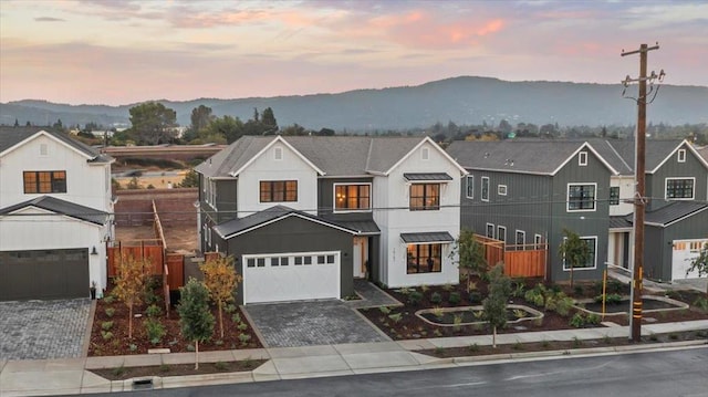 modern farmhouse style home with a garage and a mountain view