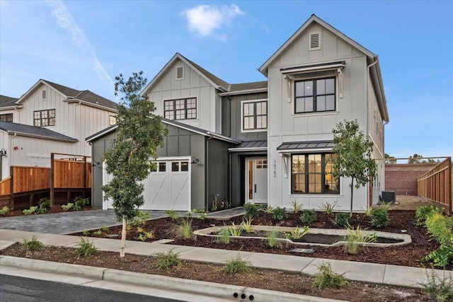 modern inspired farmhouse featuring a garage and central AC