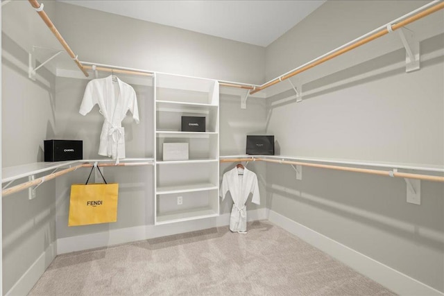 walk in closet featuring carpet flooring