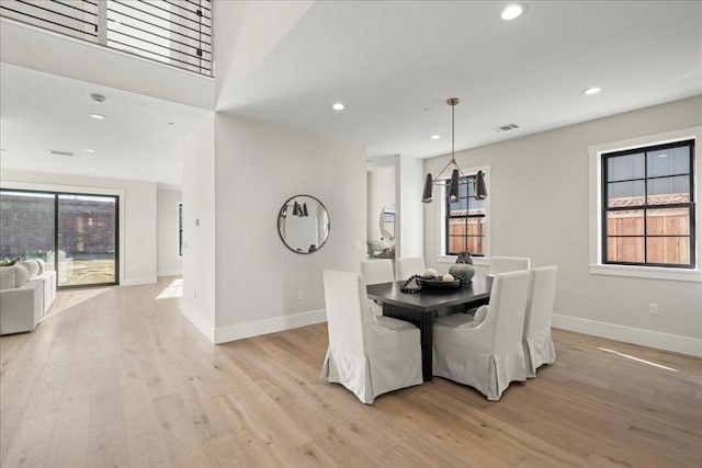 dining area with a healthy amount of sunlight and light hardwood / wood-style flooring