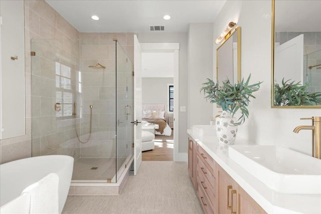 bathroom with vanity, tile patterned floors, and plus walk in shower