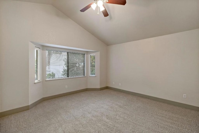 carpeted empty room featuring lofted ceiling and ceiling fan