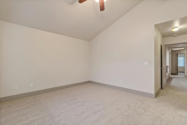 spare room with lofted ceiling, light colored carpet, and ceiling fan