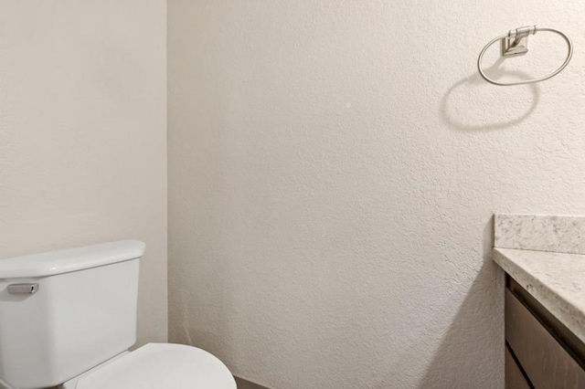 bathroom with toilet and vanity