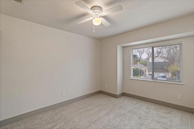 carpeted empty room with ceiling fan