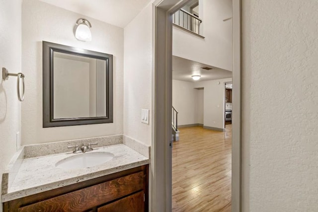 bathroom featuring hardwood / wood-style floors and vanity