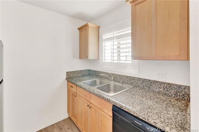 kitchen featuring light brown cabinetry, light hardwood / wood-style flooring, black dishwasher, and sink