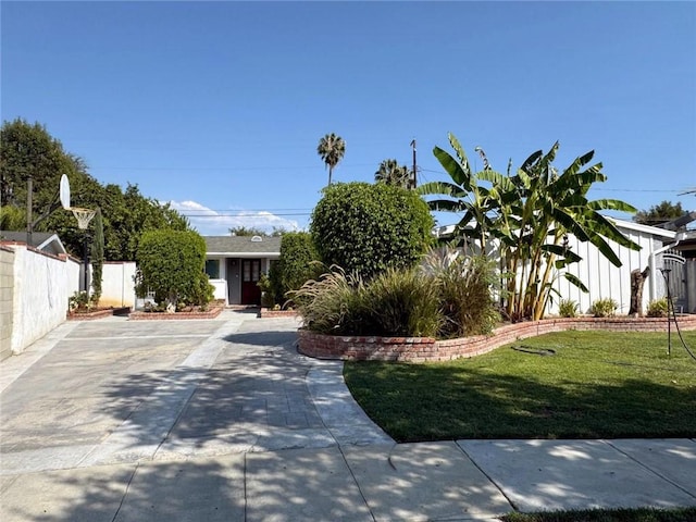 obstructed view of property with a front yard