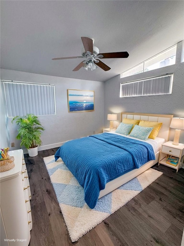 bedroom with dark hardwood / wood-style flooring, ceiling fan, and vaulted ceiling