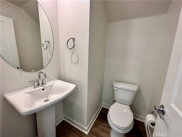 bathroom with sink, wood-type flooring, and toilet