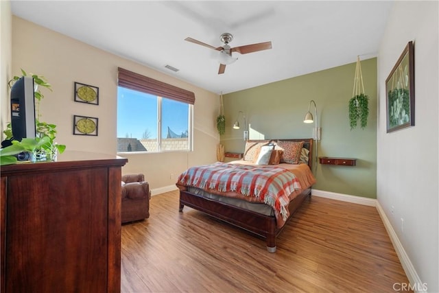 bedroom with ceiling fan and hardwood / wood-style flooring