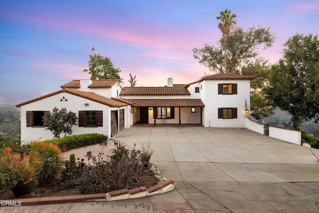 mediterranean / spanish house with a patio area