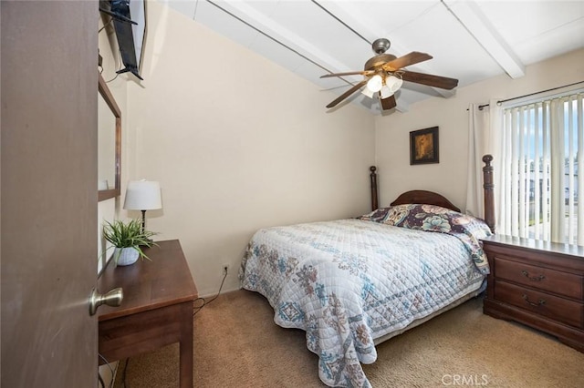 bedroom featuring ceiling fan, carpet, and beam ceiling