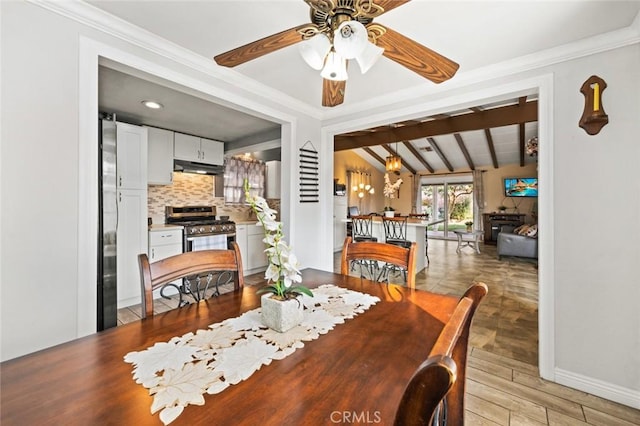 dining room featuring ceiling fan, vaulted ceiling with beams, and crown molding