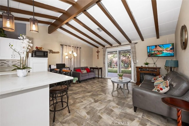 living room featuring vaulted ceiling with beams