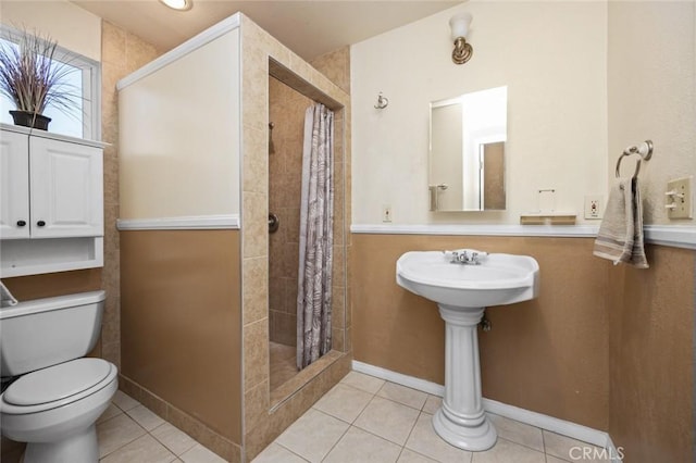 bathroom with tile patterned floors, toilet, and a shower with shower curtain