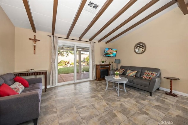 living room with vaulted ceiling with beams