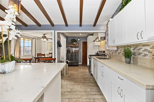 kitchen featuring white cabinetry, stainless steel appliances, sink, backsplash, and beam ceiling