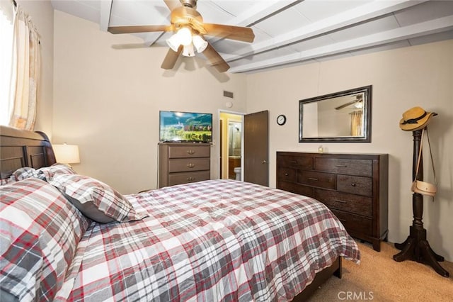 carpeted bedroom with ceiling fan and beam ceiling